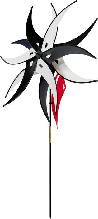 Black and White Spinning Jester with Rotating Windsail displayed in a garden, showcasing two 27-inch wheels and a fun design spinning in the wind.