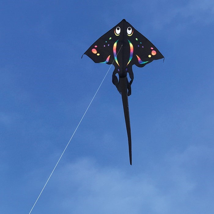 Black Stingray Kite soaring high with a 6-foot wingspan and beautiful applique design against a clear blue sky.