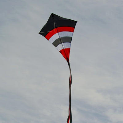 Blazer Arch 27" Diamond Kite with colorful arcs displayed against a blue sky, showcasing its vibrant design and tails.