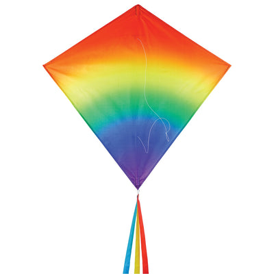 Blended Rainbow 30-inch diamond kite showcasing vibrant colors with flowing tails, soaring against a blue sky during a sunny day.