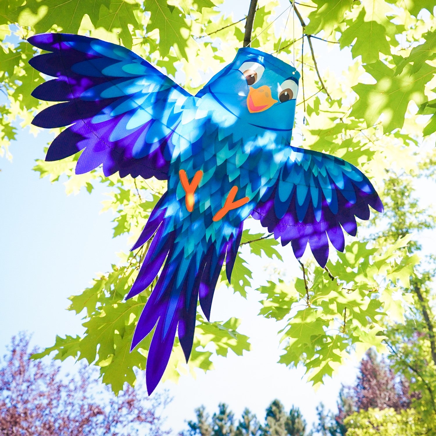 Colorful Blue Bird Windsock hanging from a pole, featuring spreading wings and vibrant design, swaying gently in the breeze.