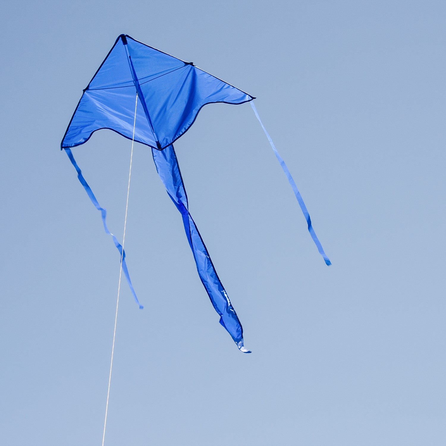 Blue Colorfly 43 inch Fly-Hi Kite soaring in the sky, featuring a solid blue design, crafted for easy flying and outdoor enjoyment.