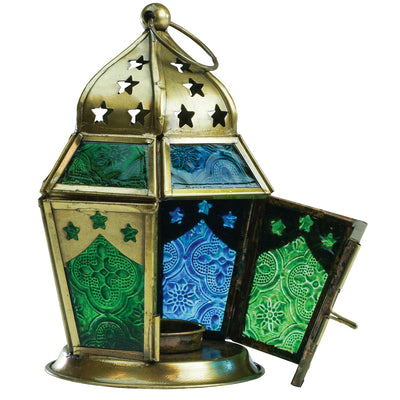 Blue & Green Hex Glass Tealight Lantern hanging in a garden, showcasing textured panels and an antiqued brass top, designed for tealight candles.