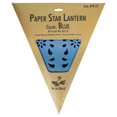 Blue Paper Star Lantern with intricate cutouts, hung indoors, providing a glowing ambiance in a boho-inspired setting.