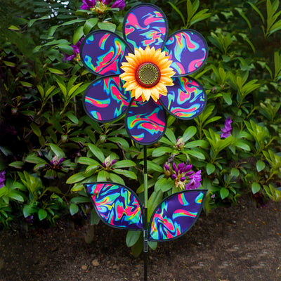 16 inch Blue Psychedelic Flower with Leaves garden spinner showcasing six petals, sunflower center, and leaves attached to a stand in a vibrant outdoor setting.