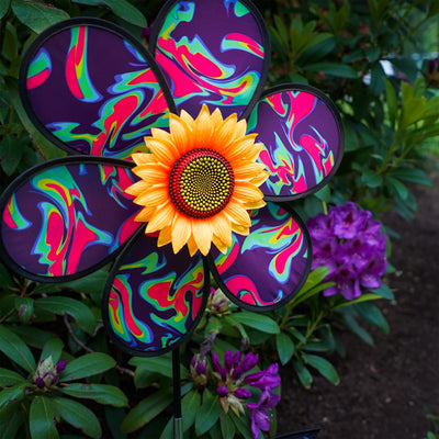 16 inch Blue Psychedelic Flower with Leaves garden spinner showcasing six petals, sunflower center, and leaves attached to a stand in a vibrant outdoor setting.