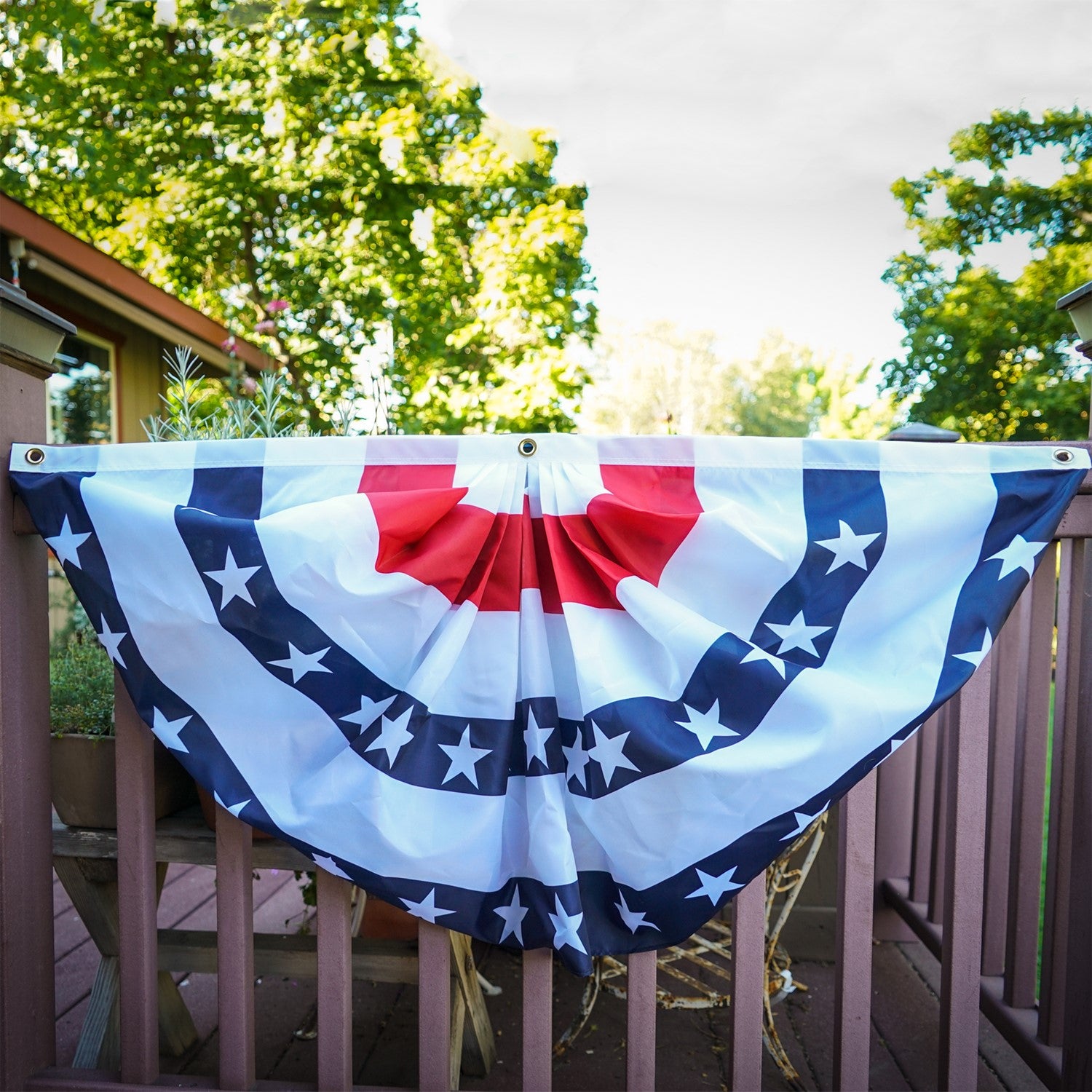 Blue Stripe Printed Bunting, featuring pleated half-circle design with brass grommets, displayed outdoors, ideal for patriotic decorations.