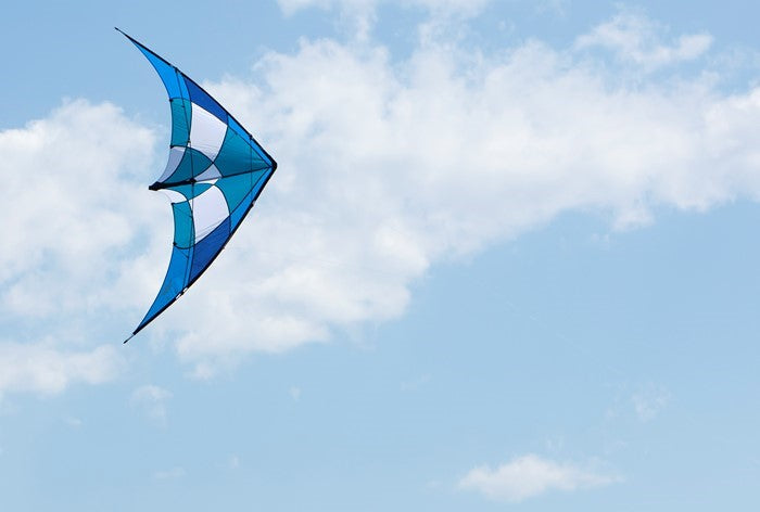 Blue/Teal Alpha + 3 kite with Dyneema lines in a clear sky, showcasing its ripstop nylon fabric and aerodynamic design.