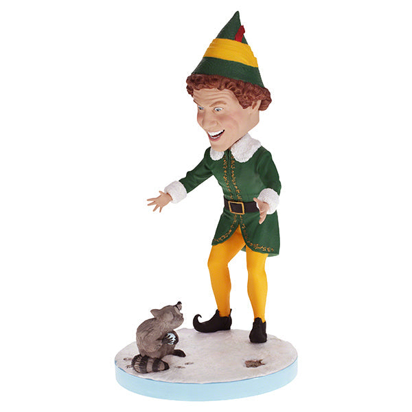 Buddy the Elf with Raccoon bobblehead standing on a shelf, showcasing vibrant colors and playful design, perfect for holiday decor.
