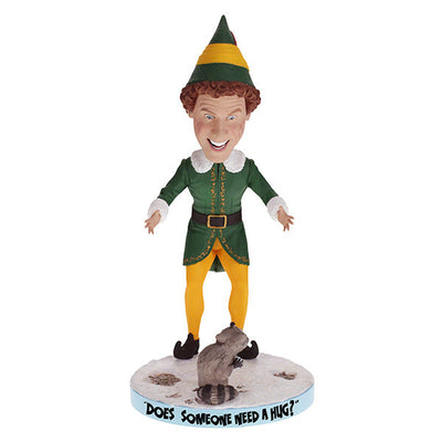 Buddy the Elf with Raccoon bobblehead standing on a shelf, showcasing vibrant colors and playful design, perfect for holiday decor.