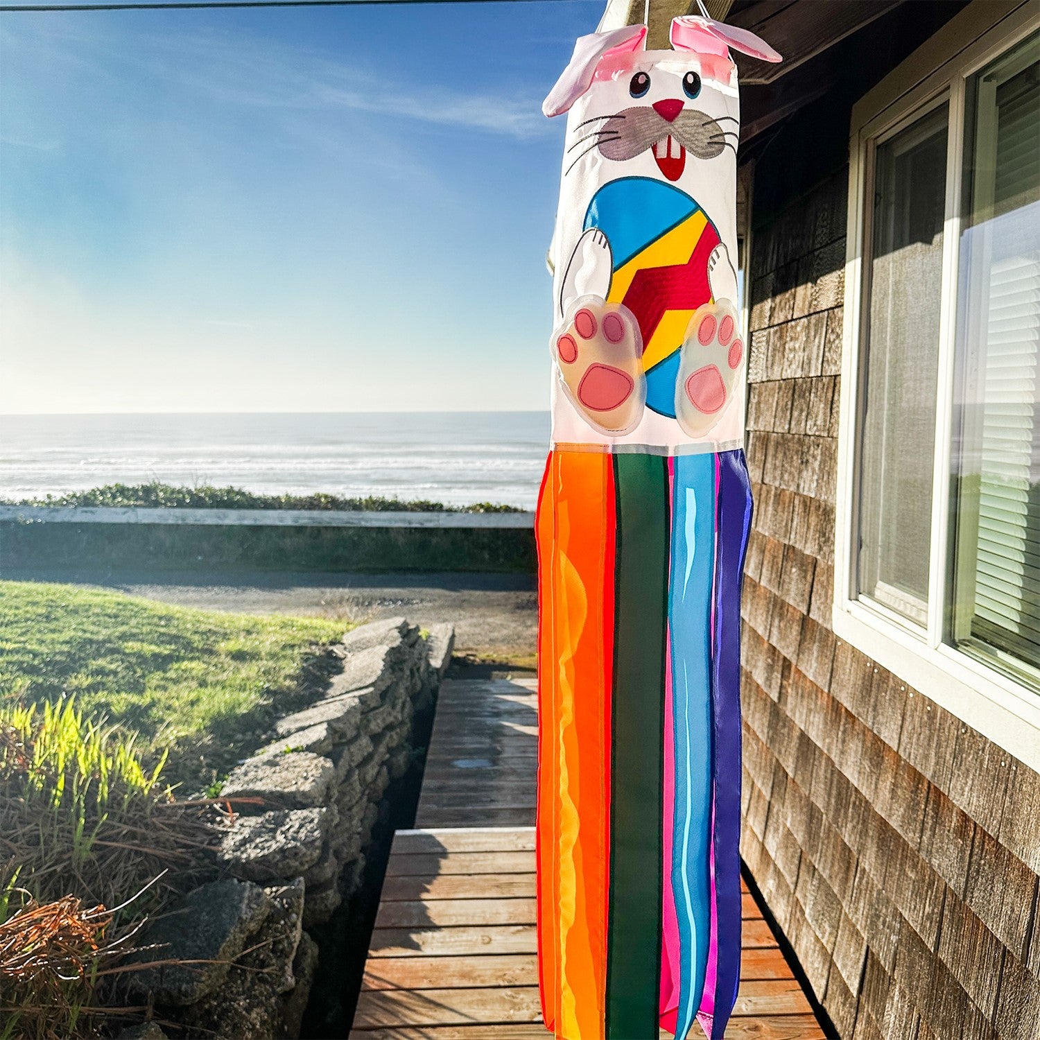 Bunny 3D Windsock in a festive garden setting, featuring vibrant colors and detailed embroidery, designed for seasonal decorations.
