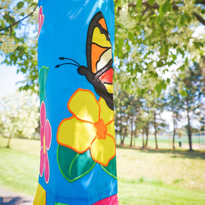 Butterfly 40-inch windsock with bright colors and detailed applique graphics hanging outdoors, fluttering in the breeze against a sunny backdrop.