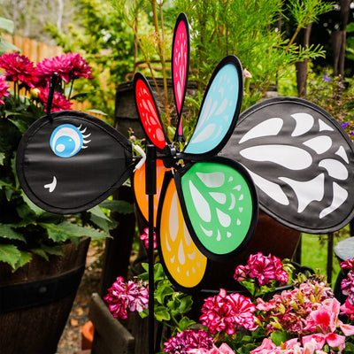 Colorful Butterfly Baby Spinner with baby butterfly design spinning on a garden pole, showcasing bright colors in a sunny outdoor setting.