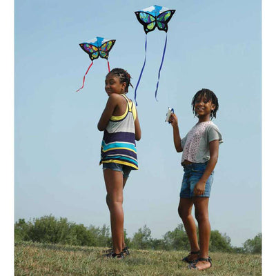 Butterfly Kite - Rainbow Orbit soaring in a clear sky, showcasing its vibrant butterfly design and ripstop polyester fabric against the sun.