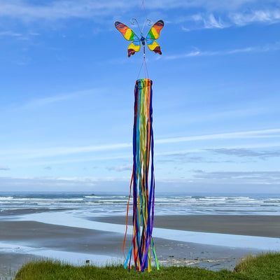 Butterfly & Ribbon Windsock featuring rainbow satin ribbons and a colorful resin butterfly, swaying gently in an outdoor setting.
