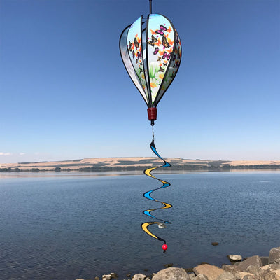 Butterfly Swarm Hot Air Balloon spinning in a garden, featuring colorful butterfly graphics and clear plastic mount for stability.