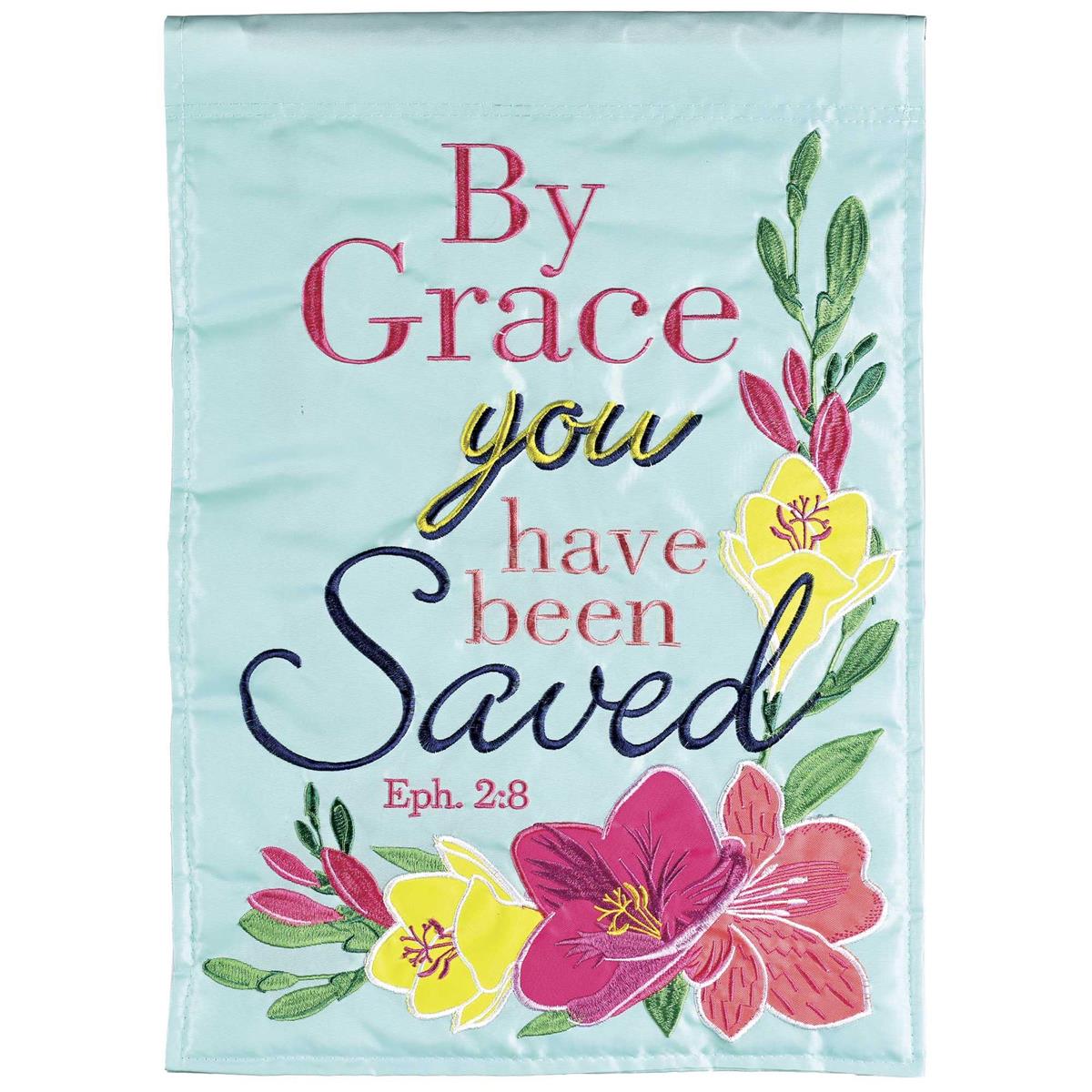 By Grace You Have Been Saved banner flag displayed in an outdoor garden, featuring intricate fabric appliques and detailed embroidery.
