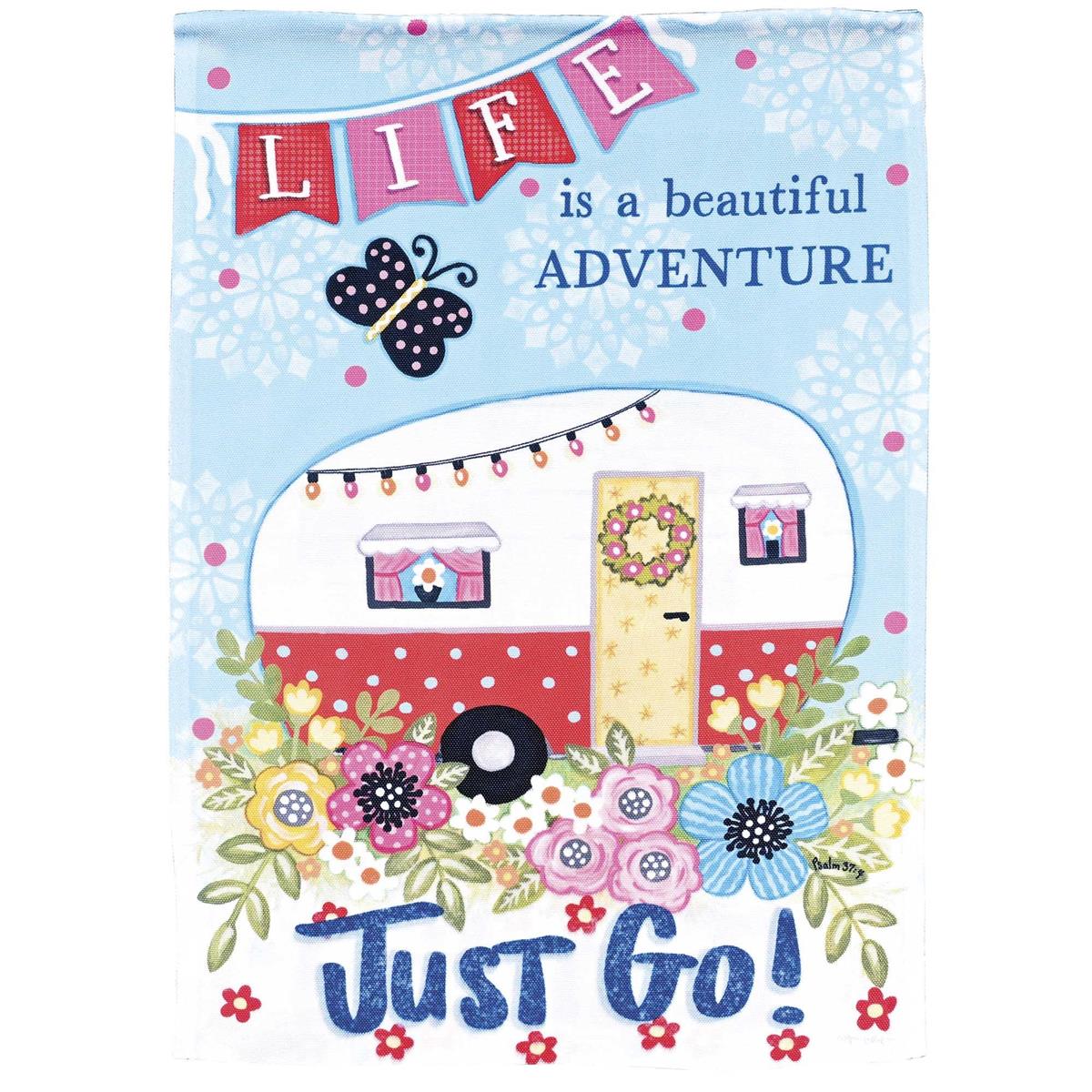 Camper Life Is A Beautiful garden flag showing a colorful design displayed in a garden, highlighting its stained glass effect from sunlight.