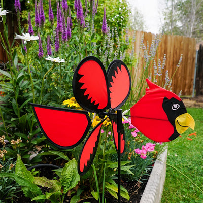 Colorful Cardinal Baby Spinner featuring a bright baby cardinal on a rotating wheel against a lush garden background.