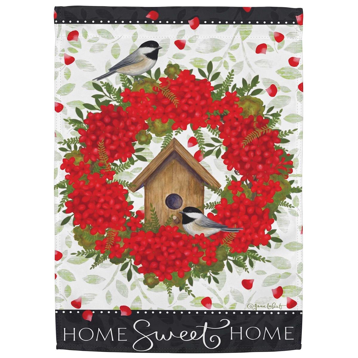 Chickadees Home Sweet Home garden flag featuring a cheerful chickadee perched on a home design, displayed in a lush garden setting.