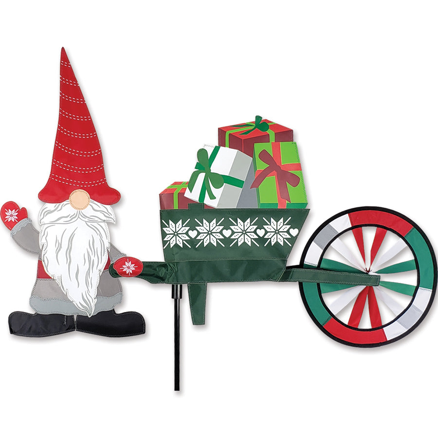 Christmas Gnome & Wheelbarrow Spinner, 24 inches tall, featuring a jolly gnome surrounded by a spinning wheelbarrow and colorful decorations in an outdoor setting.