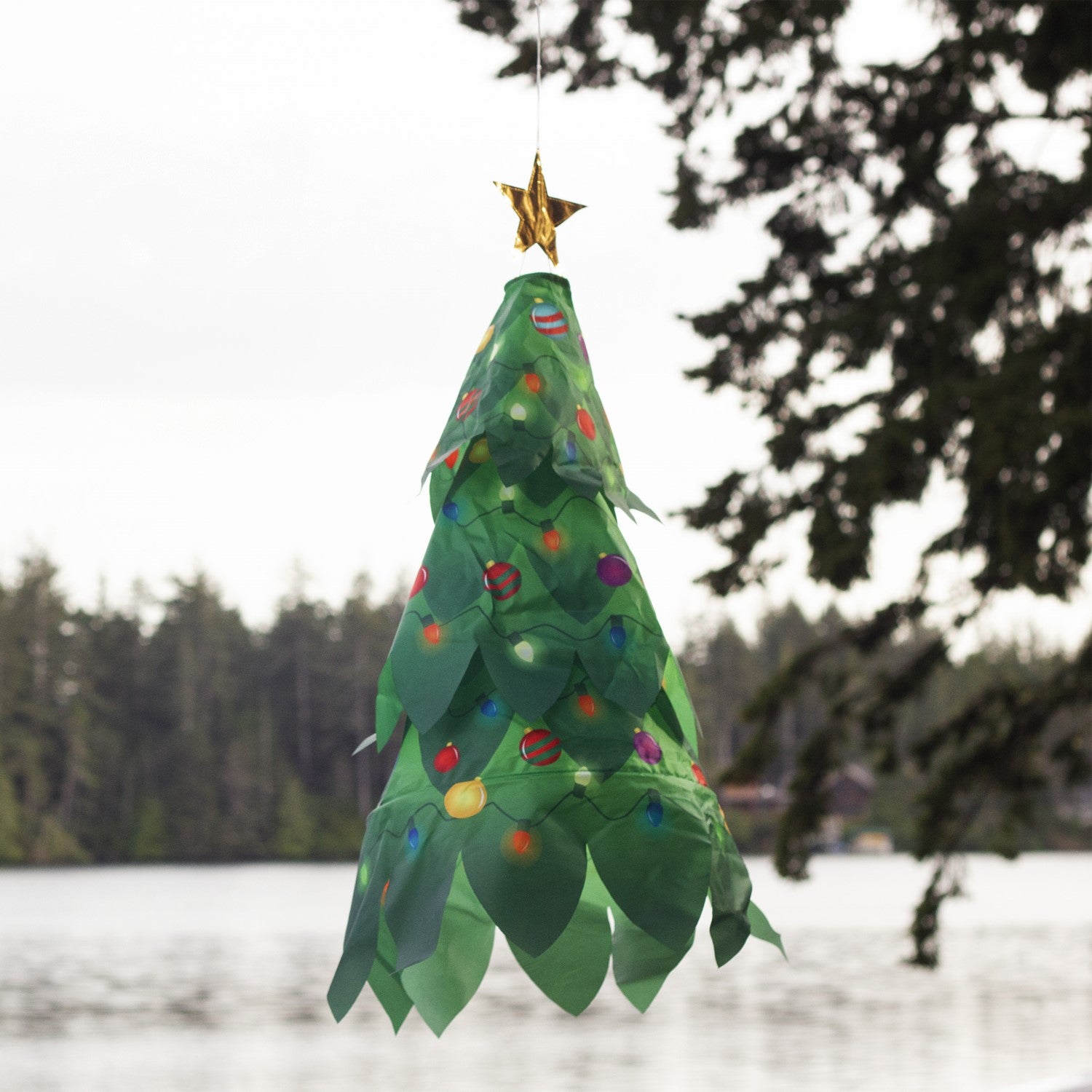 Colorful Christmas Tree 3D Windsock with a golden star displayed outdoors, showcasing vibrant colors that catch the breeze beautifully.