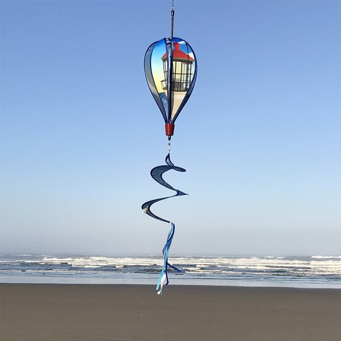 Coastal Lighthouse 6-Panel Hot Air Balloon spinner in vibrant colors with a lighthouse design hanging in a garden setting, spinning in the breeze.