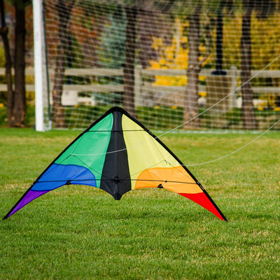 Colorwave 48" Sport Kite with a colorful rainbow design, displayed soaring in a clear blue sky, showcasing its vibrant colors and dynamic flying ability.