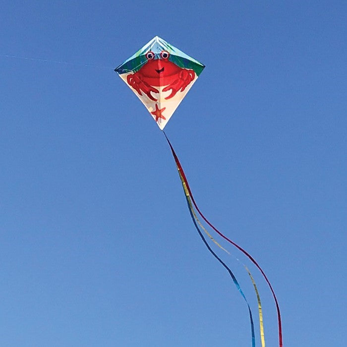 Crab 30\" Diamond Kite with colorful crab design flying high against a blue sky, featuring three tails and ready for outdoor fun.