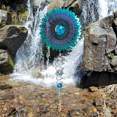 Crystal Cosmic Mandala 6.5-inch wind spinner with sparkly center and twister, visually captivating in an outdoor garden setting.