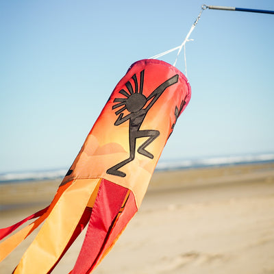 Dancing Kokopelli windsock featuring intricate graphics and vibrant colors, gracefully fluttering with the wind and enhancing any outdoor decor.