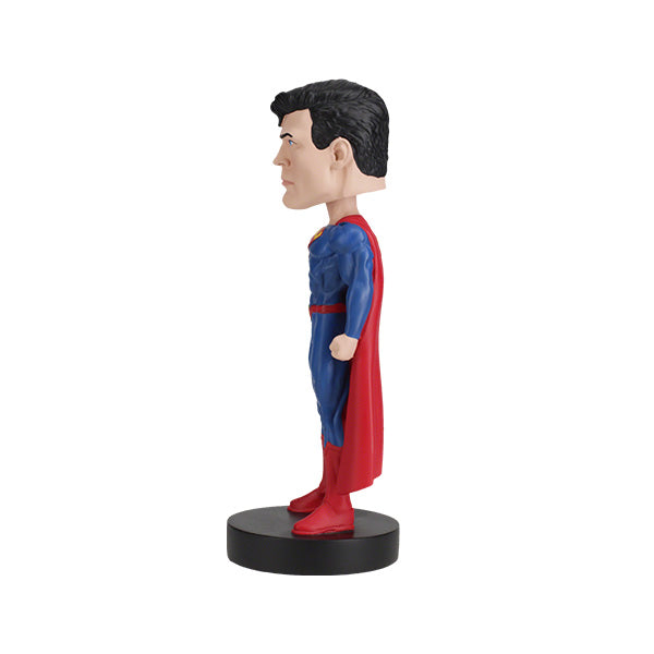 DC Comics Superman 6-inch bobblehead featuring Superman in his Rebirth suit with a vibrant red cape, placed on a display shelf.
