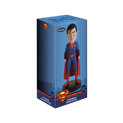 DC Comics Superman 6-inch bobblehead featuring Superman in his Rebirth suit with a vibrant red cape, placed on a display shelf.