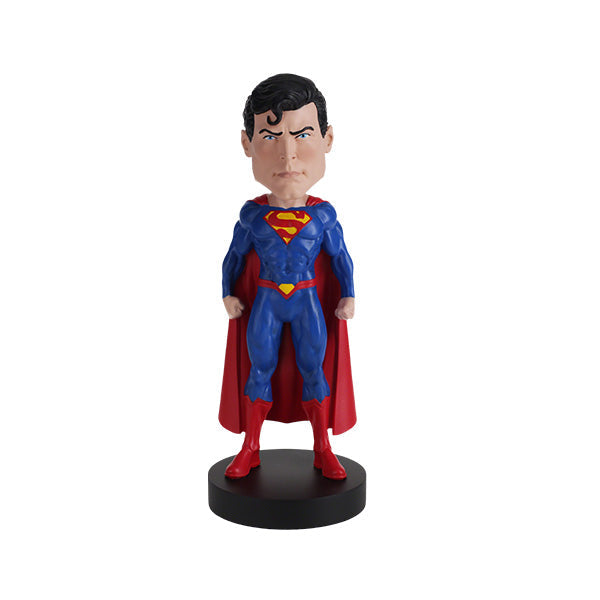 DC Comics Superman 6-inch bobblehead featuring Superman in his Rebirth suit with a vibrant red cape, placed on a display shelf.