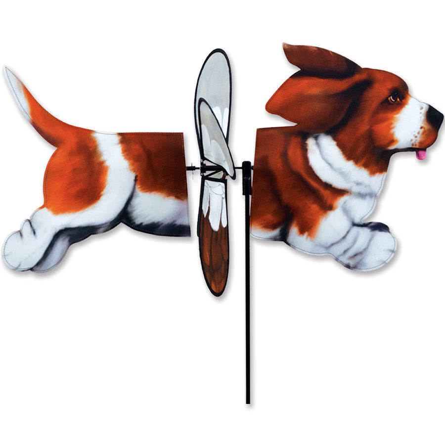 Deluxe Petite Spinner with Basset Hound design set up in a colorful garden, spinning gently in the breeze under sunlight.