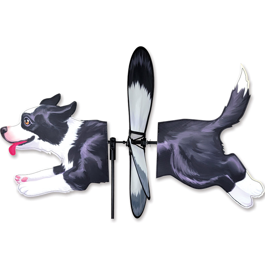 Deluxe Petite Spinner featuring a Border Collie design, gently spinning in a lush garden under a clear sky.