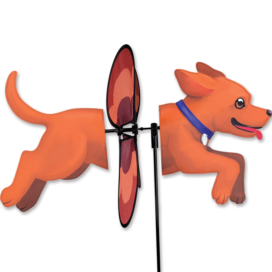 Deluxe Petite Spinner featuring a playful dog design, spinning gracefully in a garden setting, showcasing its vibrant colors.