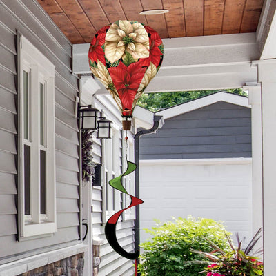 Hot air balloon spinner with red poinsettias, holly, and greenery, made of weather-resistant polyester for elegant, festive holiday outdoor garden décor.