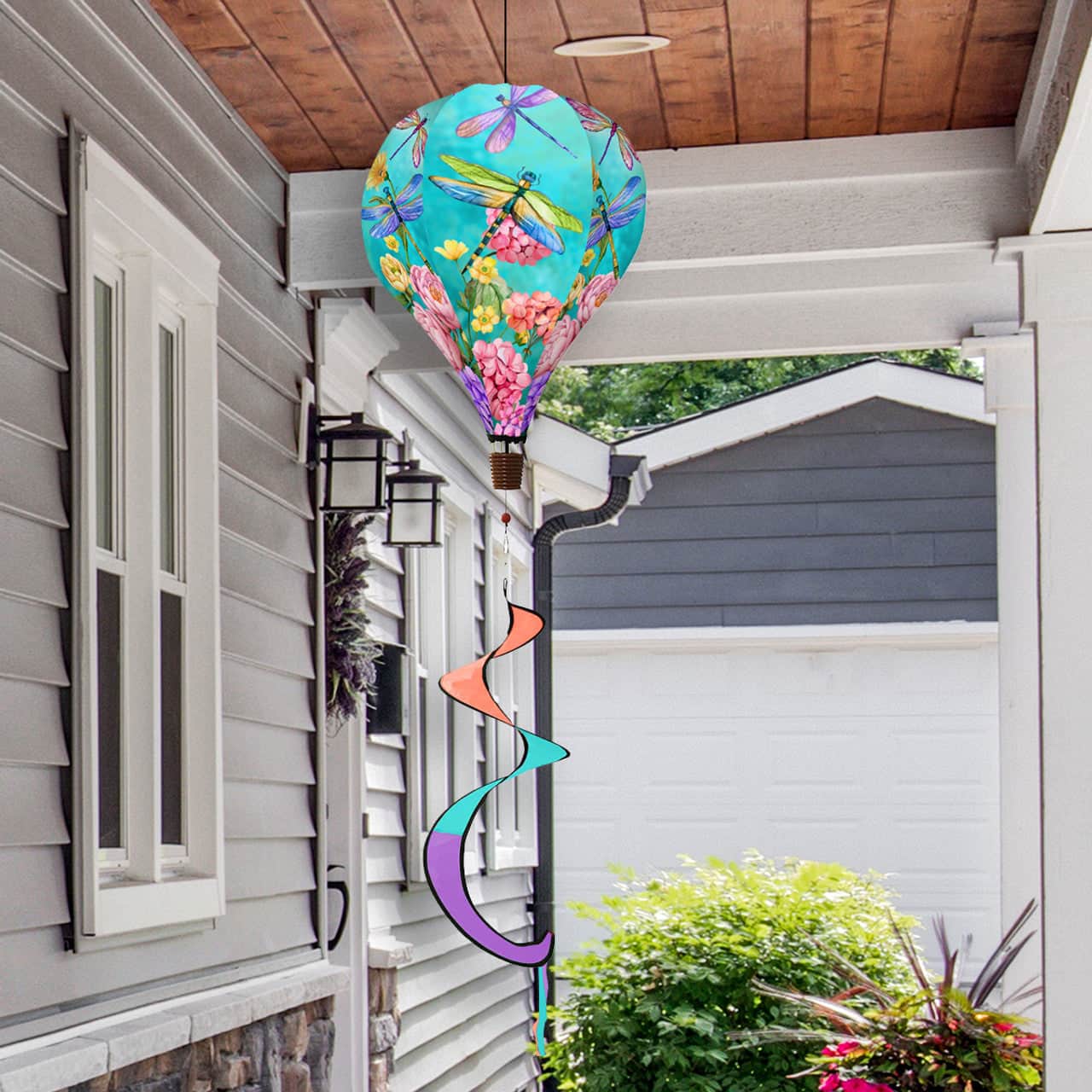 Hot air balloon spinner with dragonflies and blooming flowers, crafted from weather-resistant polyester for elegant spring and summer garden décor in motion.