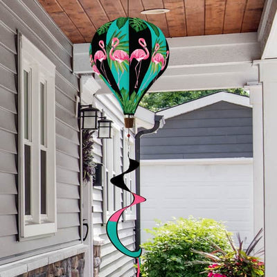 Hot air balloon spinner with pink flamingos and tropical greenery, made of weather-resistant polyester for colorful, breezy outdoor summer garden décor.