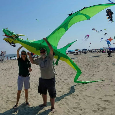 Giant green dragon kite with a 14.5-foot wingspan, open jaw, trailing tail, and carbon tube framing for powerful wind lift and sky dominance.