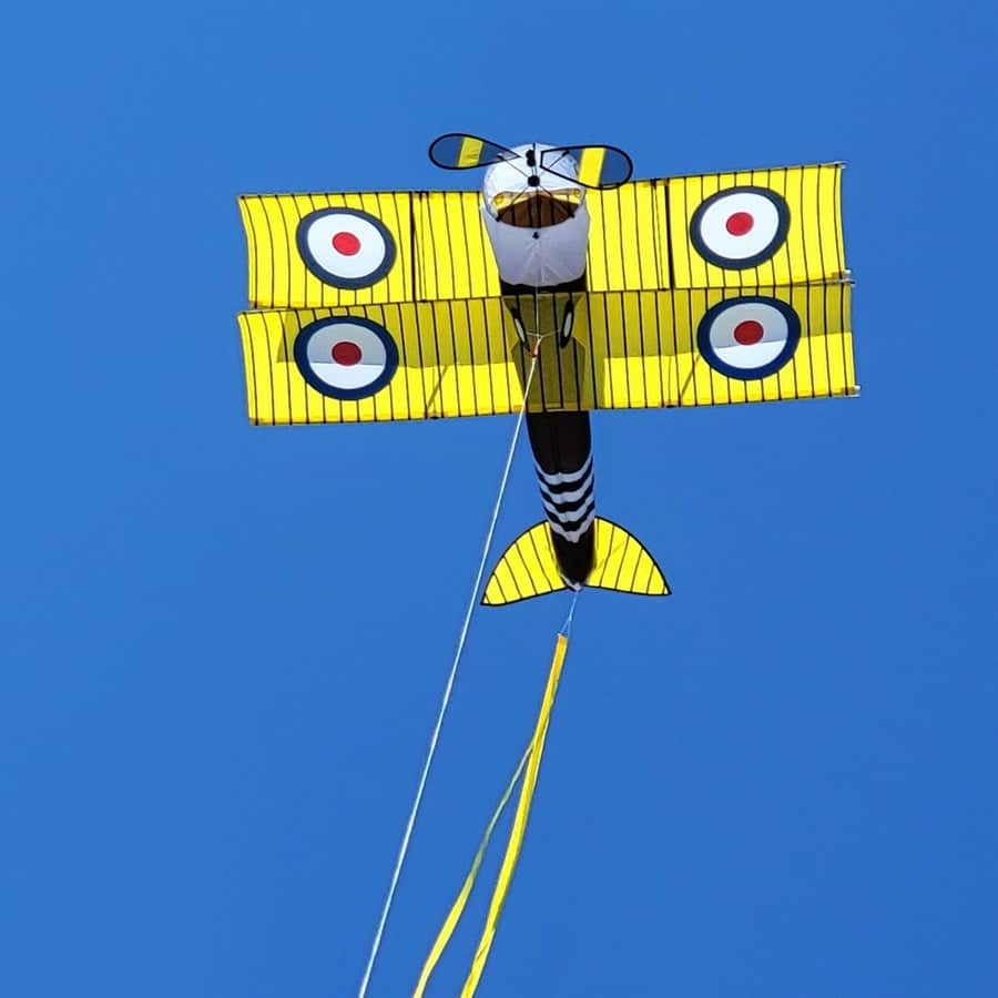 Giant 65 inch Sopwith Camel biplane kite with vintage roundels, spinning propellers, durable frame, and 130 lb. line with storage case included.