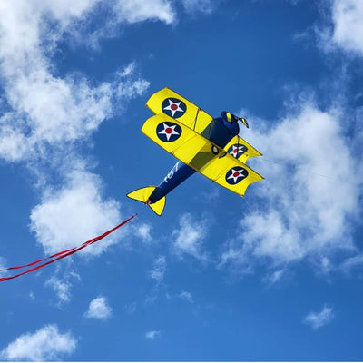 Giant 65 inch Stearman biplane kite with spinning props, ripstop polyester sail, fiberglass frame, and included 130 lb. line and vinyl case.