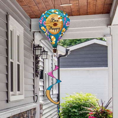 Hot air balloon spinner with buzzing bees, floral accents, and golden beehive design in weather-resistant polyester for joyful, breezy outdoor garden décor.
