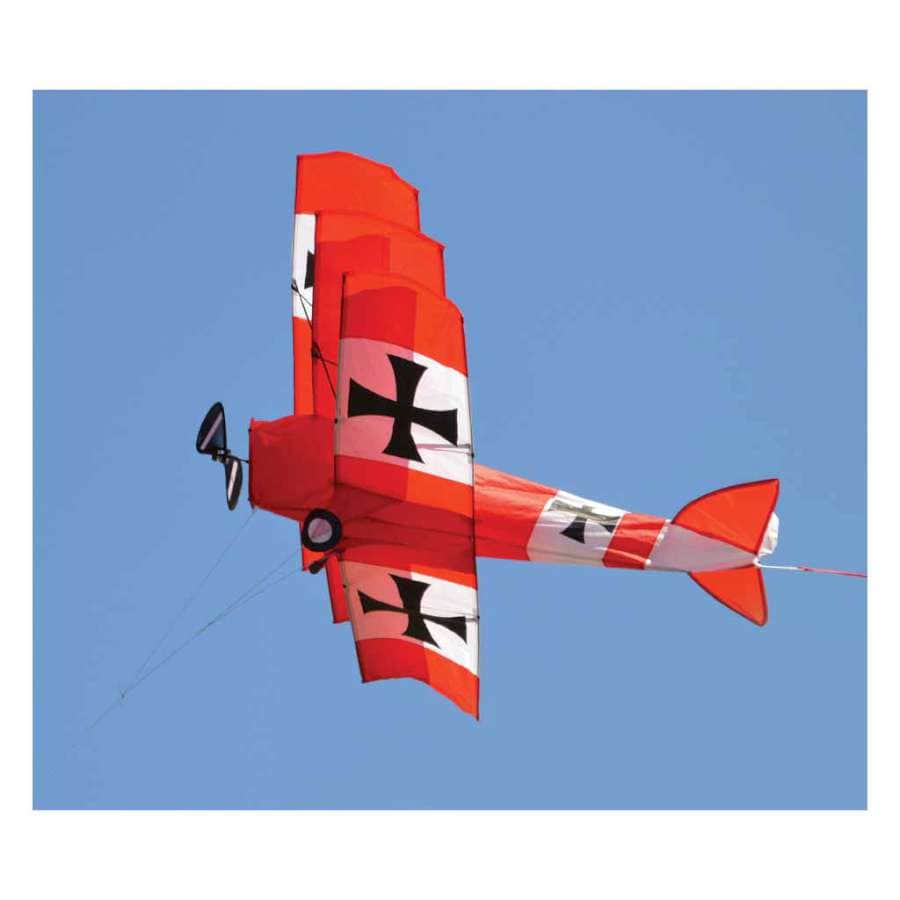 Red Baron tri-plane kite with WWI-style graphics, spinning propellers, durable construction, and smooth flight. Line and handle included.
