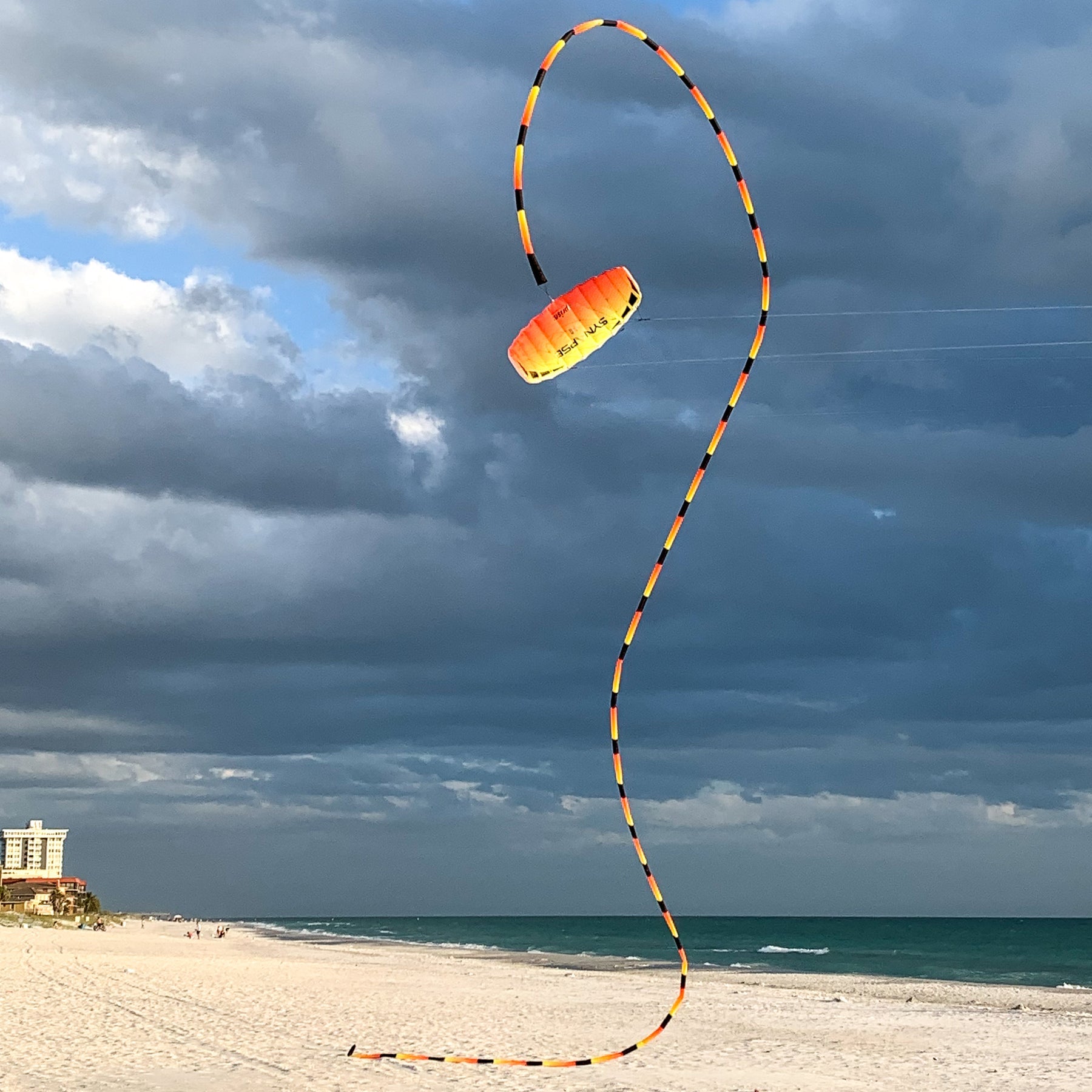 Infrared tube tail with red, orange, and yellow gradient, inflating tubular construction, and swivel clip for dynamic kite motion and visibility.