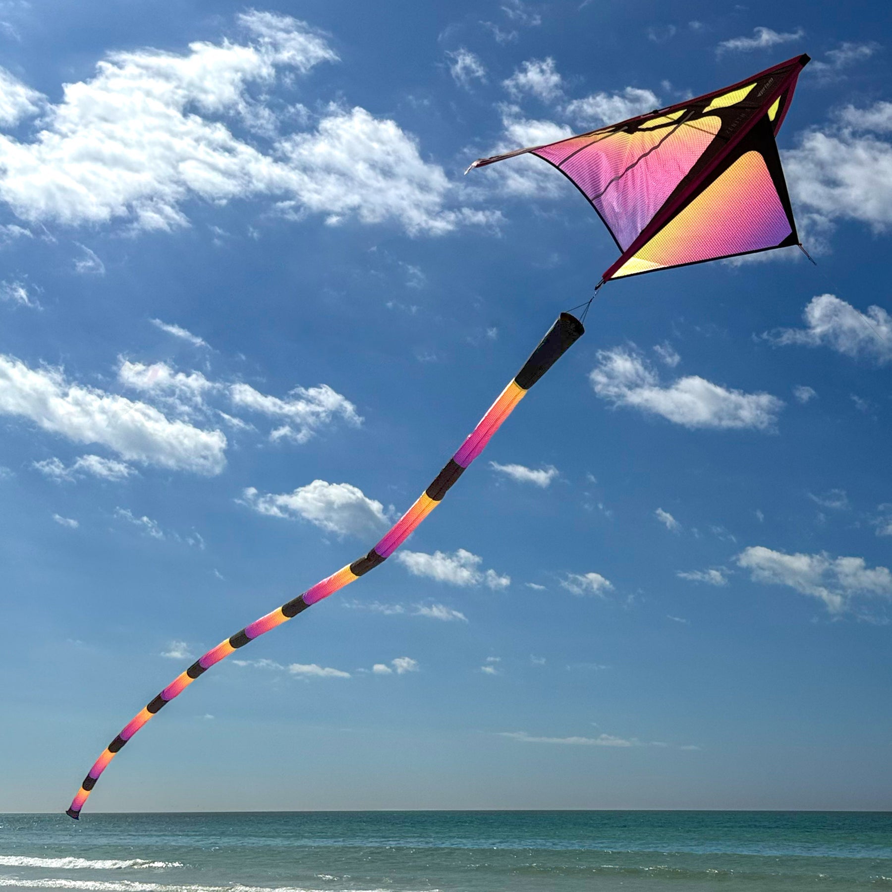 Plasma tube tail with yellow, pink, and purple gradient design, inflating airflow construction, and swivel clip for dynamic kite displays.