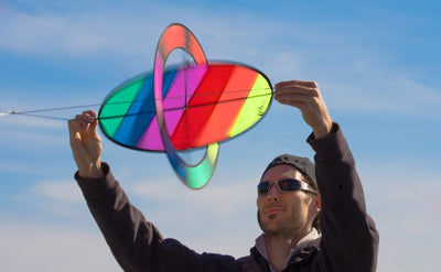 Rotor-style kite with spinning wing creates a colorful, gyroscopic flight display powered by the Magnus Effect.