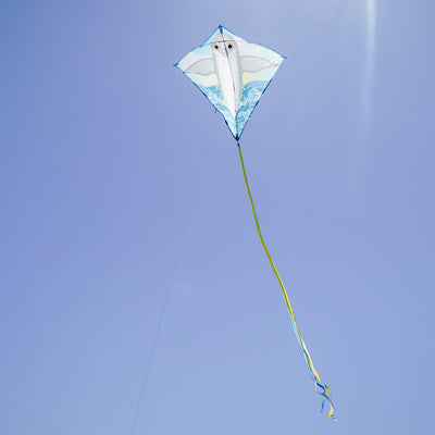 Dolphin 30 inch Diamond Kite soaring in the sky featuring a bright dolphin design, three color-coordinated tails stretching behind it.