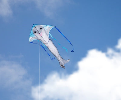 Dolphin 45-inch Fly-Hi Kite flying high in a blue sky, featuring a vibrant dolphin design and colorful streamer tails.